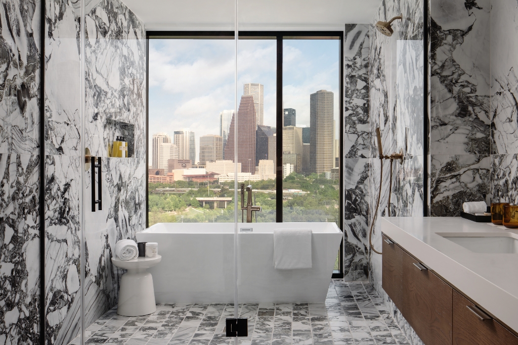thompson houston bathroom with dallas skyline views