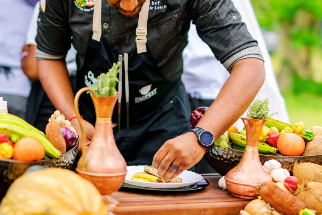 culinary food festival stand with chef plating food
