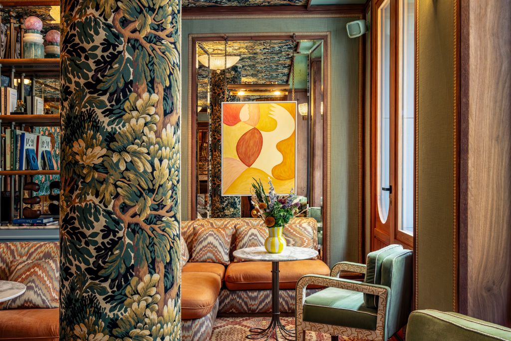 la fantaisie hotel salon with bright artwork and botanical columns