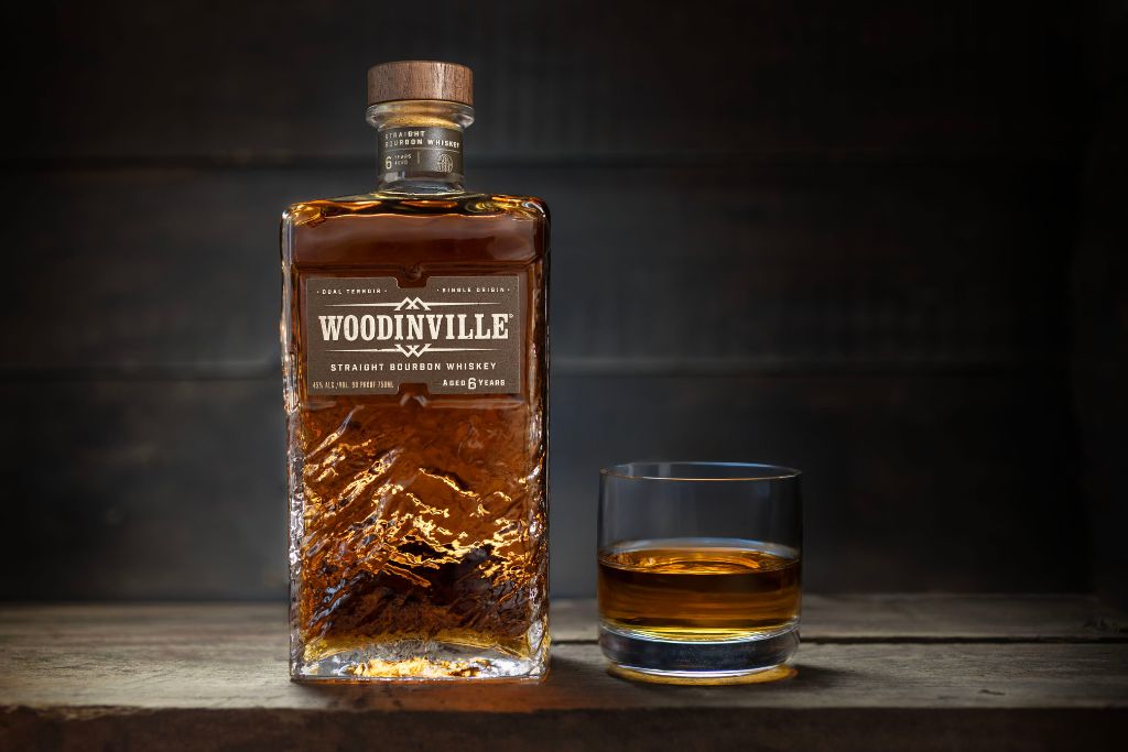 bottle and glass of woodinville bourbon whiskey
