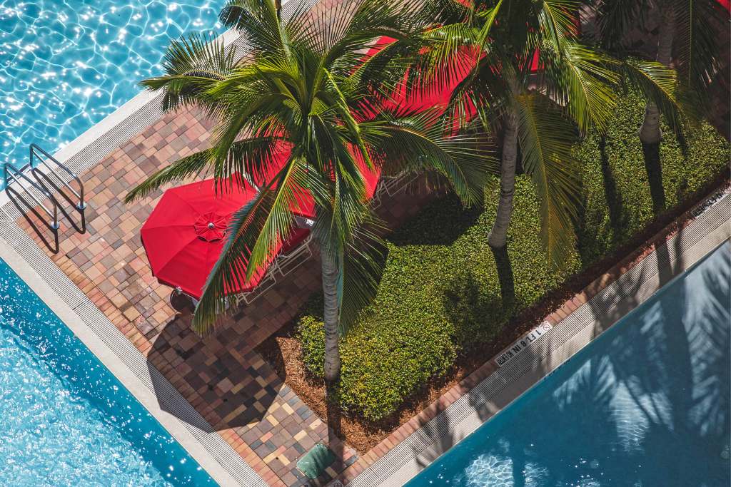 pool with signature red umbrellas at acqualina resort & residences Florida
