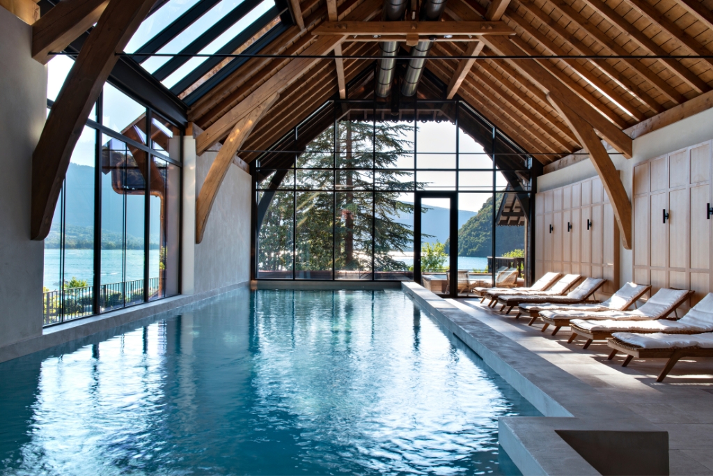 light-filled indoor spa pool with lake views at auberge du père bis
