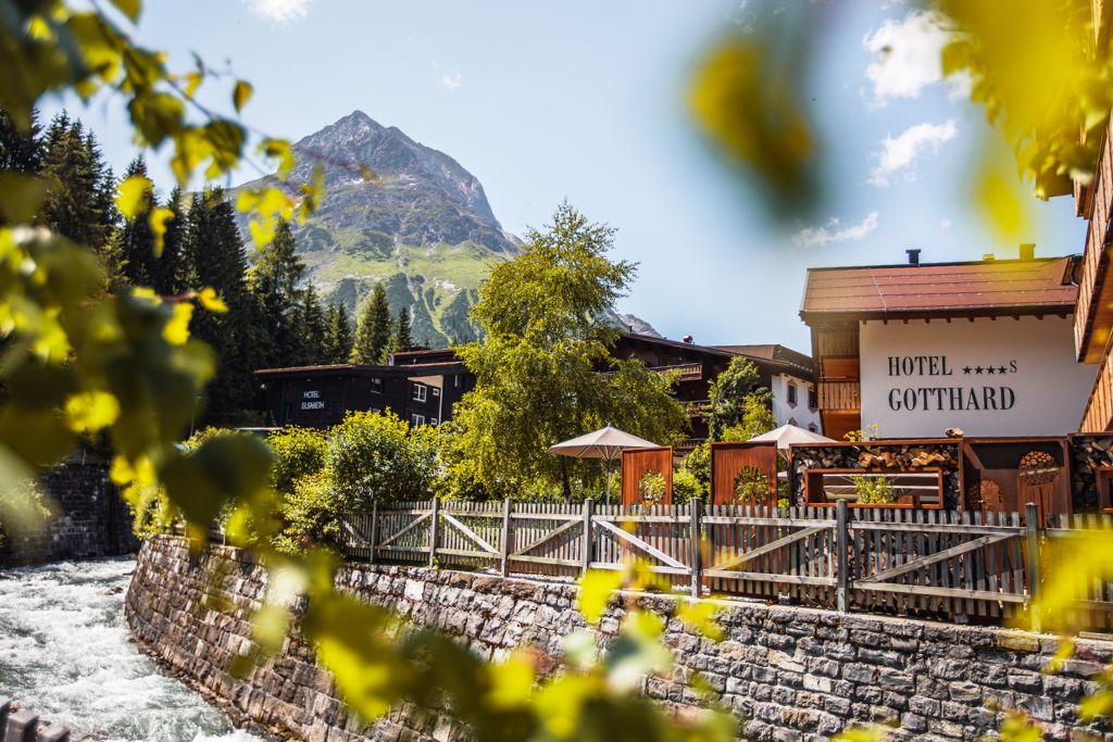 hotel gotthard exterior with mountains in the background