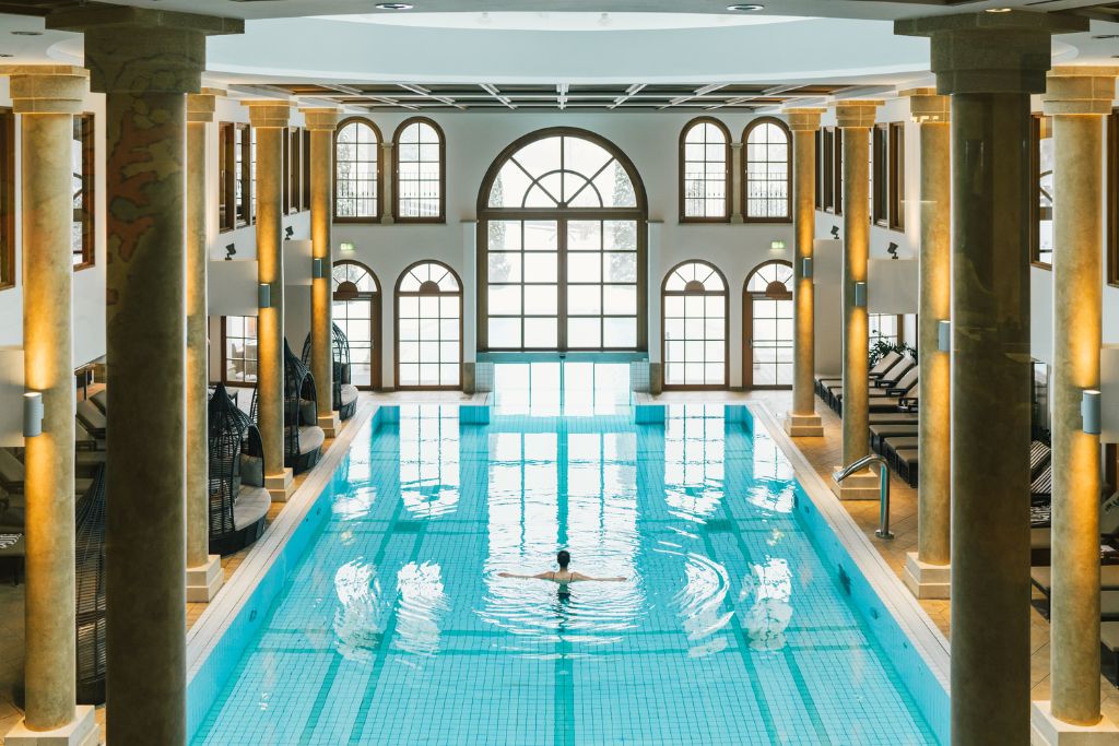 pool at schlosshotel kitzbuhel with high ceilings and columns