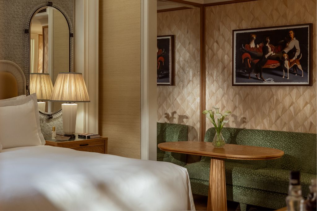 executive king suite with a green couch and hound painting