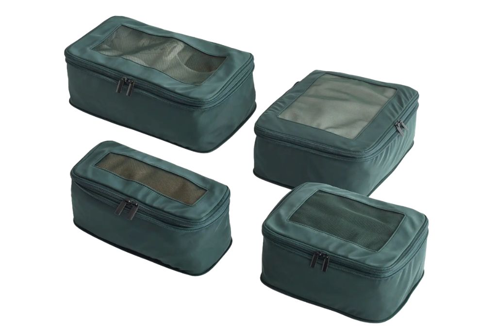 four differently sized green compression packing cubes