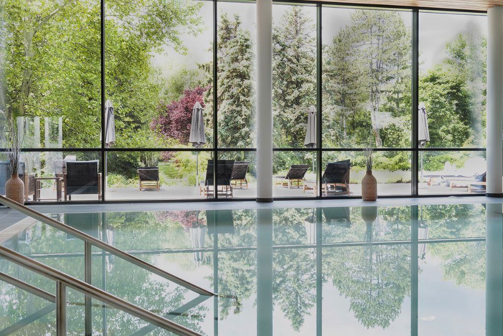 hotel marienkron indoor pool with floor to ceiling glass windows