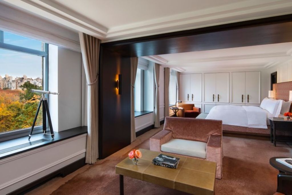 presidential suite bedroom with views of park and city skyline